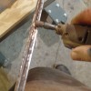 Grinding off the corrosion on the t-bar truss rod.